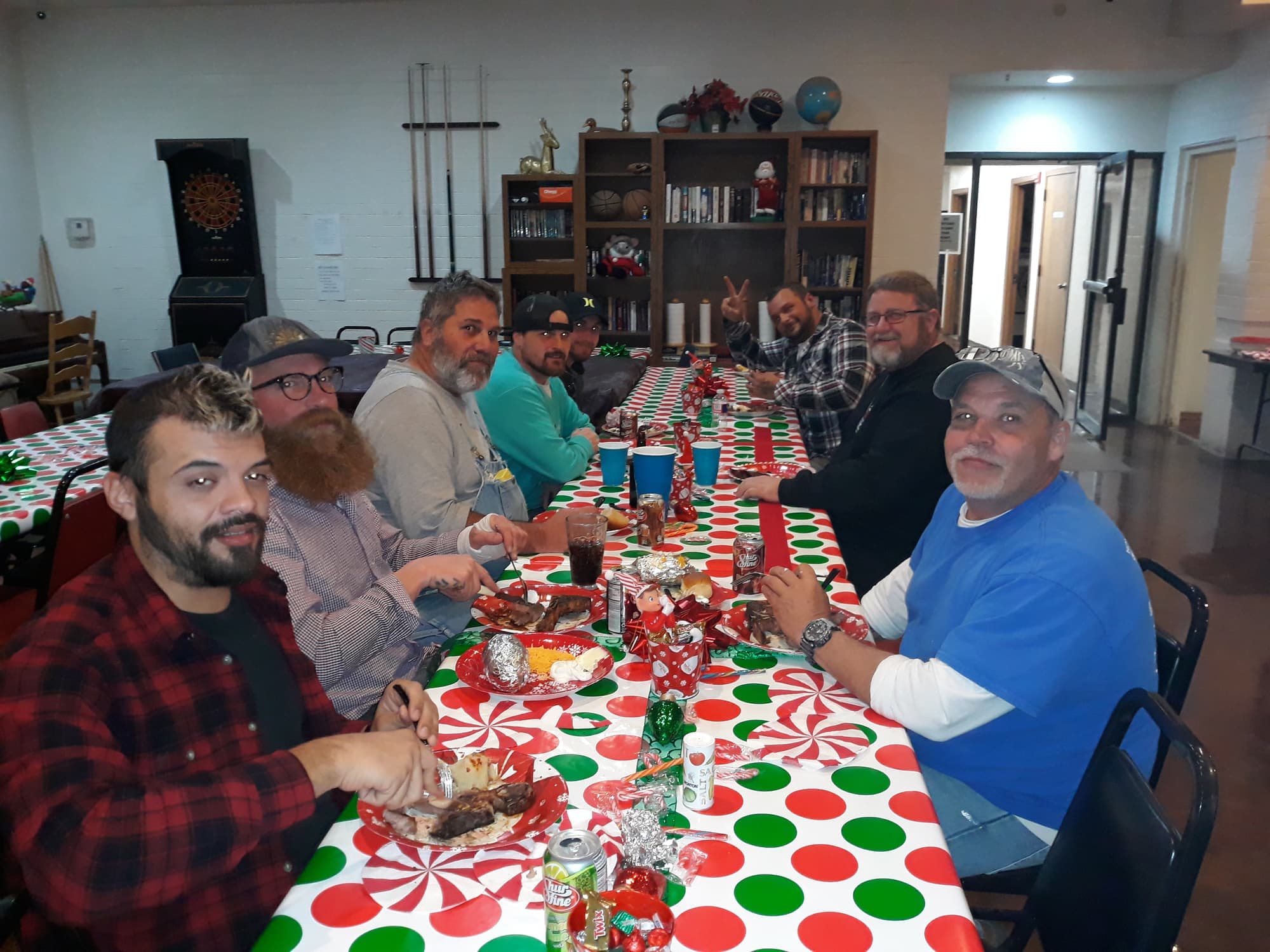 Residents and guests smiling around the long Christmas dinner table